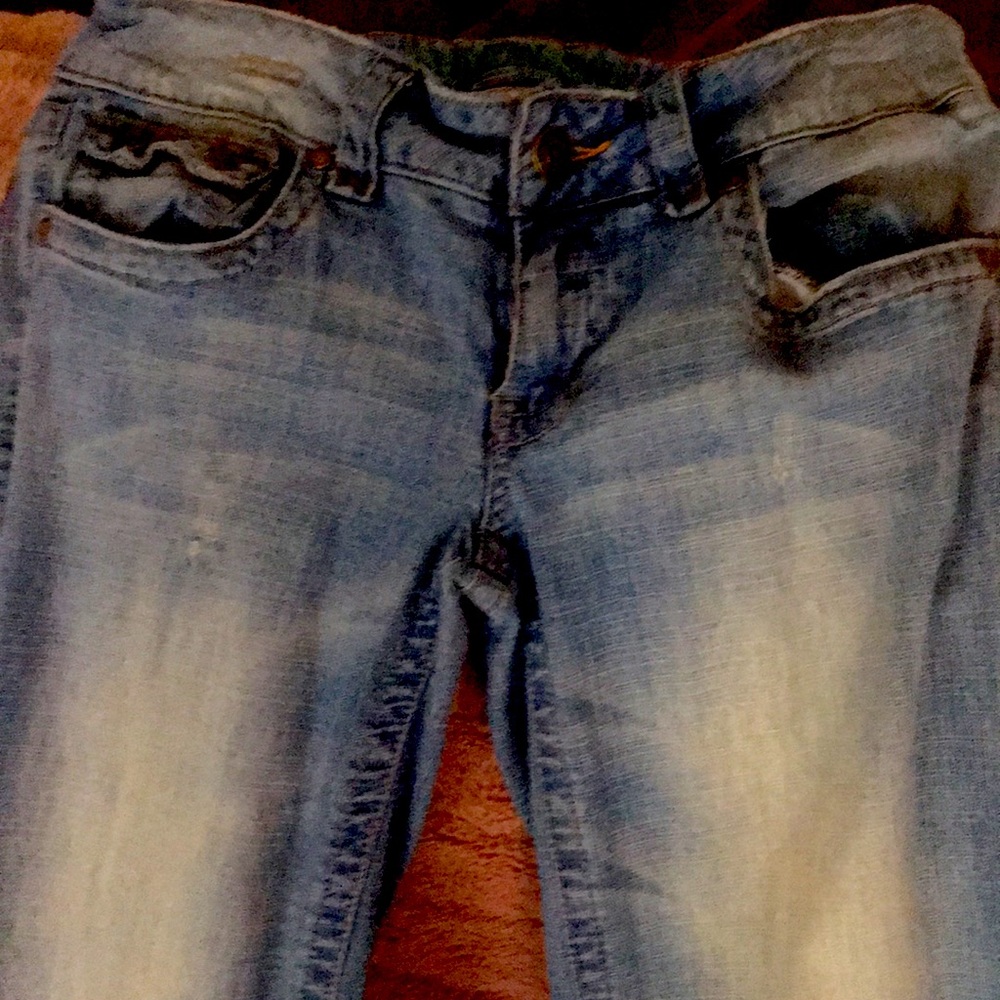 Flared jeans with back button pockets distressed